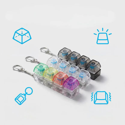 4 klavišų „clicker“ tipo antistresinis žaislas, klaviatūros imitacija, raktų pakabukas