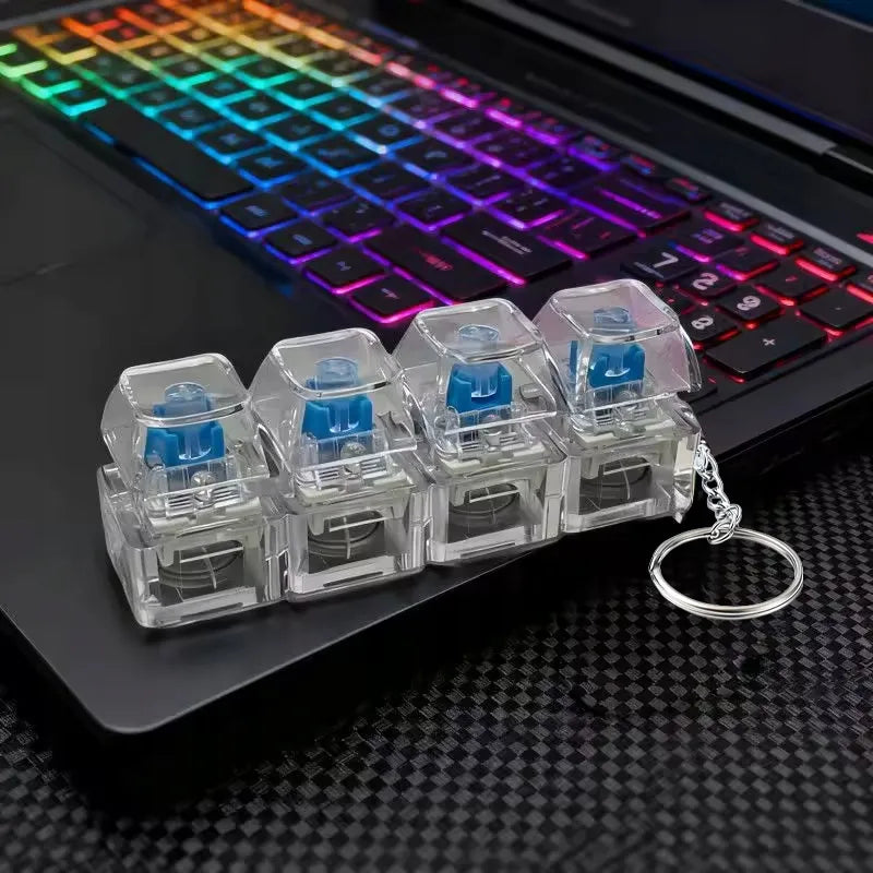 4 klavišų „clicker“ tipo antistresinis žaislas, klaviatūros imitacija, raktų pakabukas